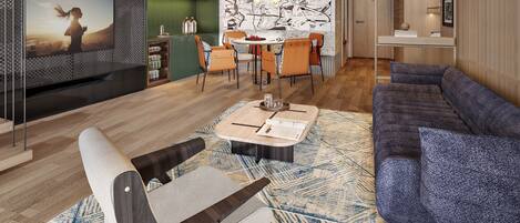 A modern living room with a sofa, a coffee table, and a TV. There is a dining area with chairs and a table.