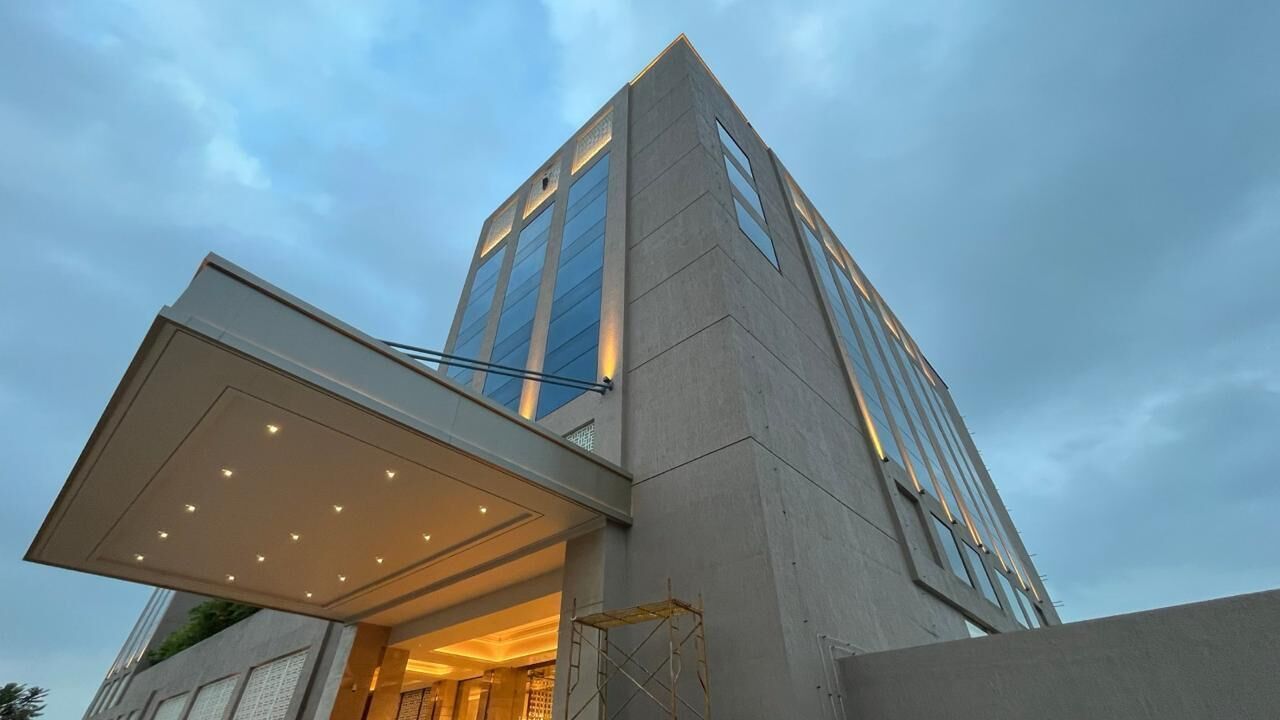 A modern building with a prominent entrance and a covered walkway.