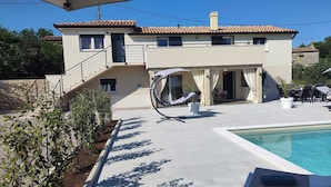 A modern two-story house with a swimming pool, outdoor seating, and a covered patio area. - 10 minutes from the sea, a newly renovated appartment for 6 person
 (labin)