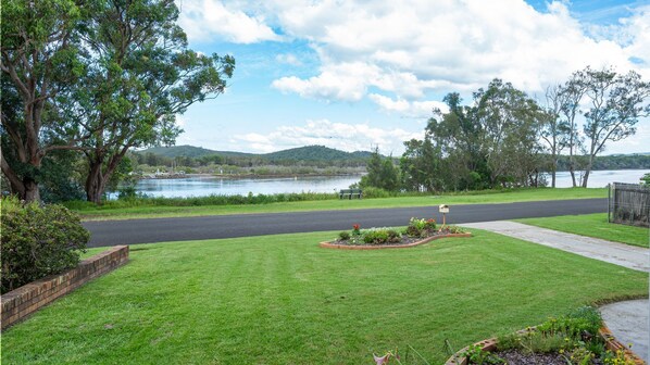 Property grounds - Retro 1BR riverfront apartment with backyard, BBQ, and easy access to water activities (Evans Head)