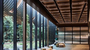 A modern interior with a long corridor, large windows, and seating areas. - Novotel Melbourne Airport (Melbourne Airport)