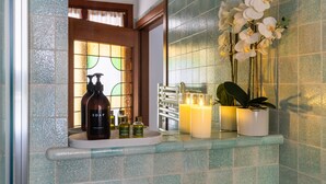 A bathroom vanity with a soap dispenser, candles, and a potted plant. - Tintoretto Cozy Duplex R&R (Venecia)
