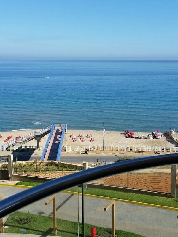 Praia particular, areia branca, espreguiçadeiras, guarda-sóis