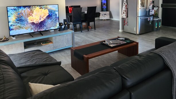 A modern living room with a flat-screen TV, a coffee table, and a sofa. - Short term stay perfect for the business traveller
Pet friendly
 (Griffith)