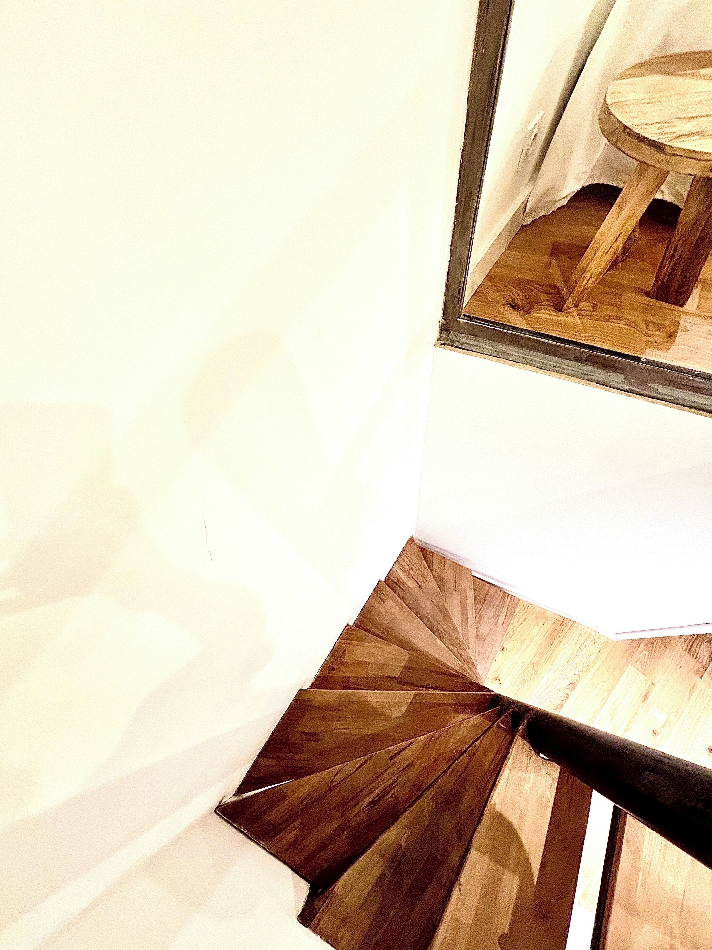 A staircase with wooden steps and a metal handrail.