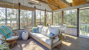 A wooden deck with a sofa, chairs, and a table. - Dog-friendly Westover Cottage w/ River Access! (Westover)