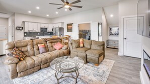 A spacious living area with a sofa set, a glass coffee table, and a ceiling fan. - Lakefront Seneca Vacation Rental w/ Shared Dock! (Seneca)