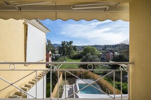 A balcony with a view of a swimming pool, a staircase, and a distant townscape. - Villa Nina with Private Plunge Pool by Konnect, 5 km to Corfu Town (Corfu)