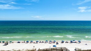 A beach with white sand, clear blue water, and a wooden boardwalk leading to the shore. - Stella Marina - Caribbean Resort 502.Bch srvc incl!!! (Navarre)