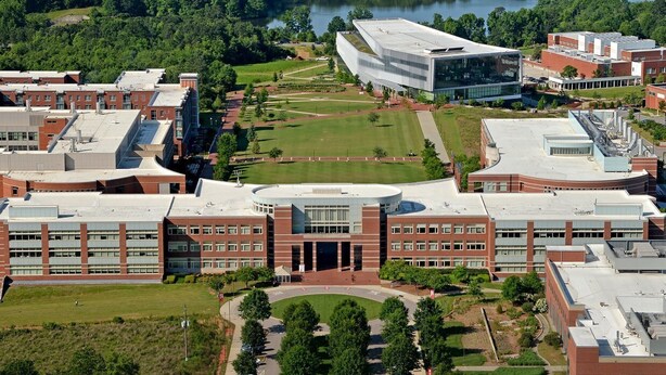 An aerial view of a campus with multiple buildings, green lawns, and a central circular plaza. - North Hills Oasis- 5mins from North Hills, Newly Renovated, Two En Suites!  (Raleigh)