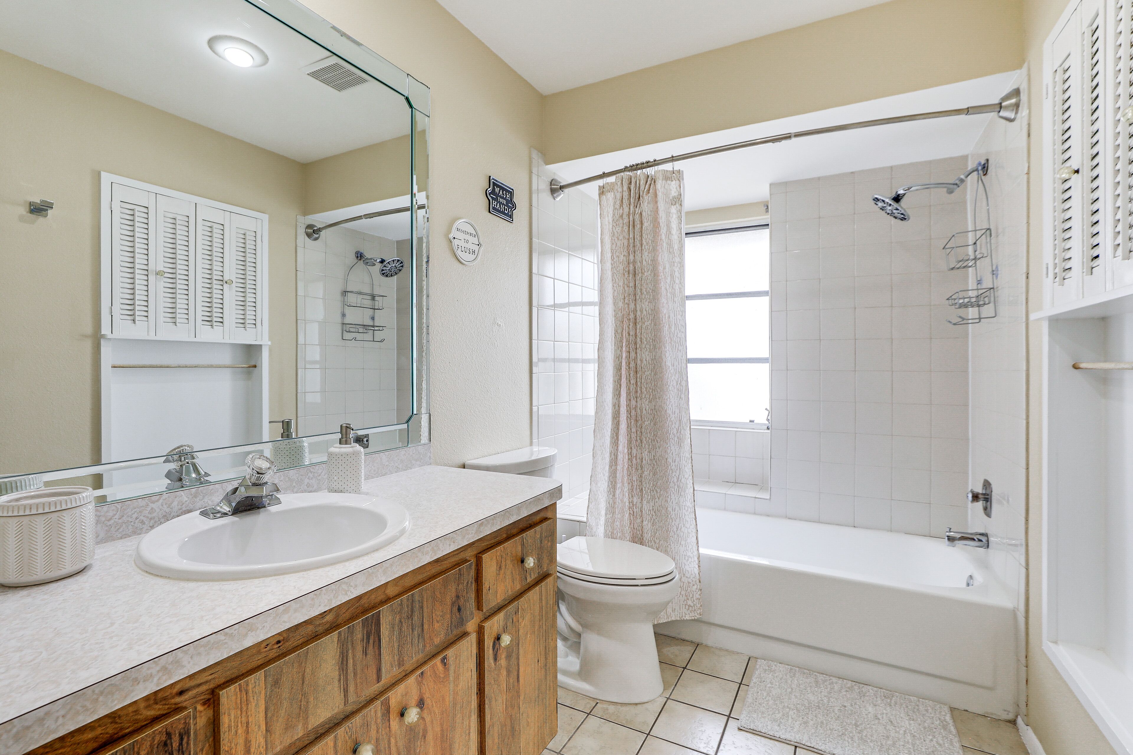 A bathroom with two sinks, a toilet, a bathtub, and a shower.