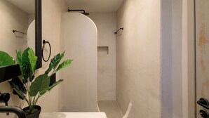 A bathroom with a shower, a toilet, and a sink. There is a potted plant near the sink. - Deluxe family room in Naxos town (shared pool)  (Naxos)
