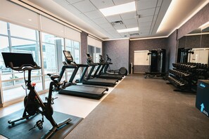 A gym with treadmills, an elliptical, and dumbbells. - Homewood Suites By Hilton Buford Mall Of Ga (Buford)