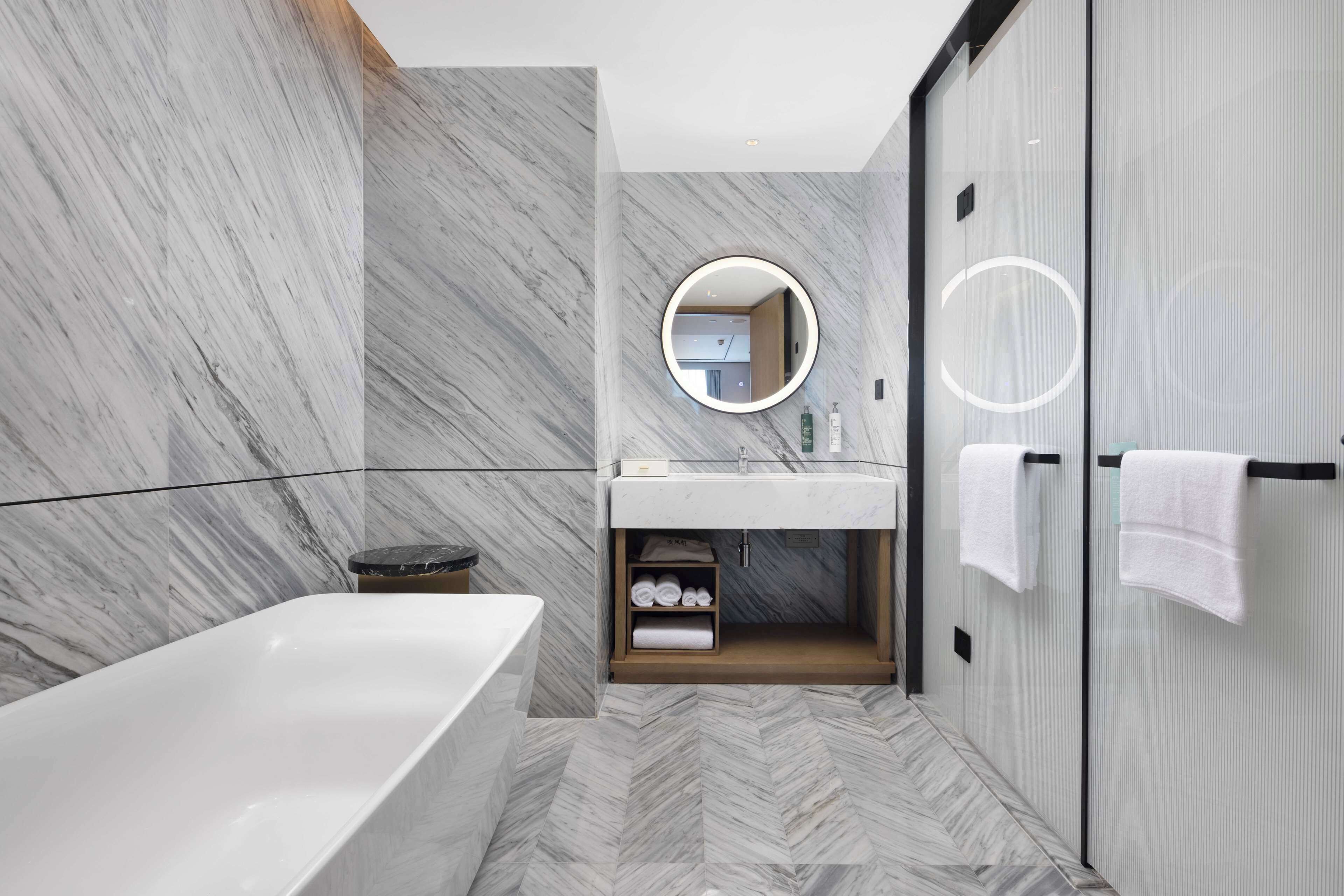 Deluxe Suite, 1 King Bed | Bathroom | Deep soaking tub, hydromassage showerhead, hair dryer, slippers