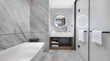 Deluxe Suite, 1 King Bed | Bathroom | Deep soaking tub, hydromassage showerhead, hair dryer, slippers