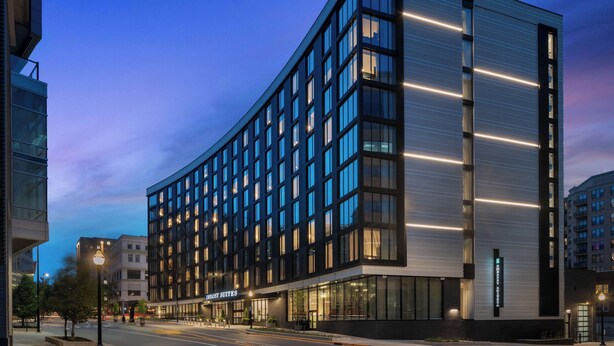 A modern hotel with a glass facade, multiple floors, and a prominent entrance. - Embassy Suites By Hilton Madison Downtown (Madison)