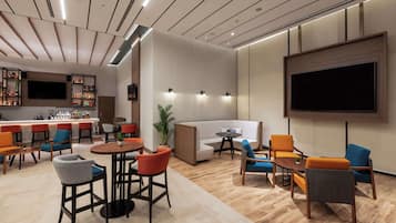 A modern lounge area with a bar, seating arrangements, and a large TV screen.