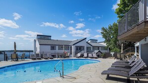 A swimming pool with lounge chairs, a deck, and a view of the water. - Lakefront Retreat w/ Community Pool in Osage Beach (Osage Beach)