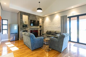 Family Villa, Slope side | Living area | 55-inch Smart TV with digital channels, fireplace, Netflix - Bali and Eva Midlands (Zenzani)