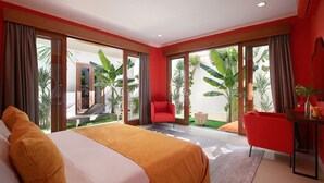 Una habitación de hotel moderna con una cama grande, un sillón rojo y un área de comedor.