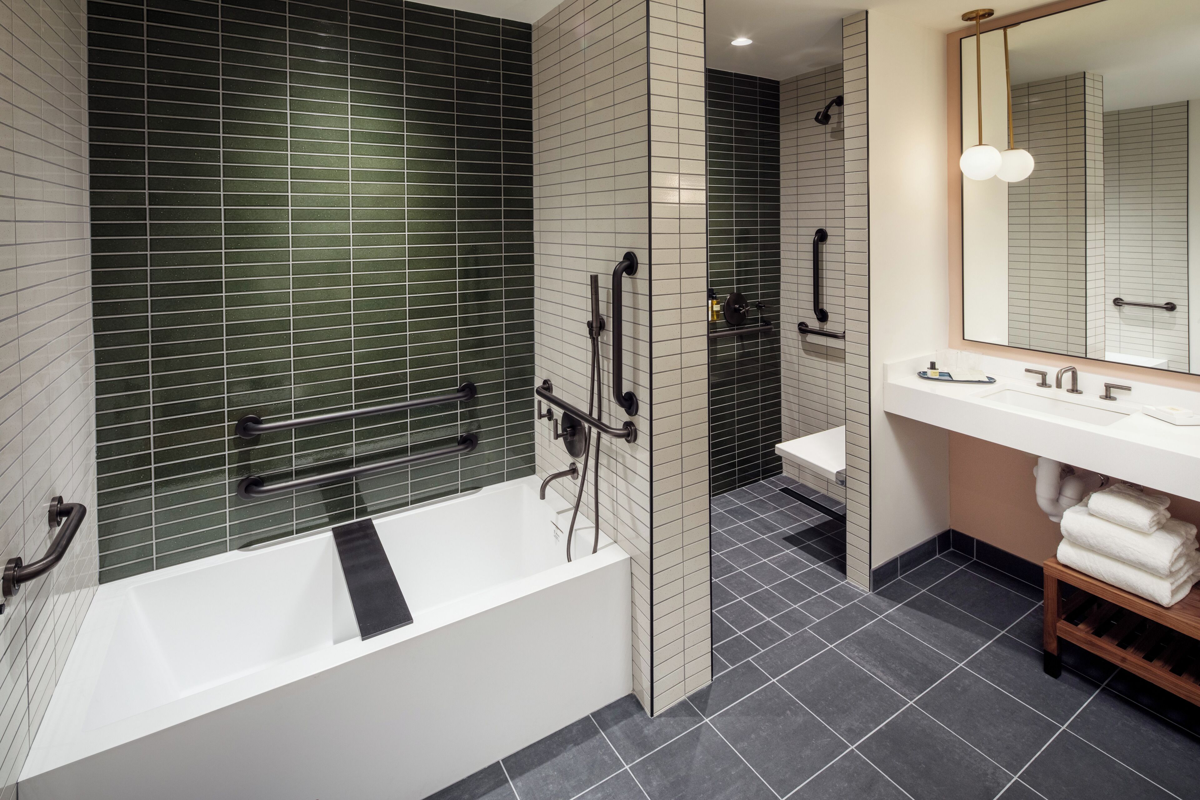 A modern bathroom with a bathtub, a sink, and a mirror.