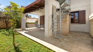 A residential property with a covered patio, outdoor seating, and a spiral staircase leading to an upper level. - 3844 Villetta Della Poesia by Barbarhouse (Melendugno)