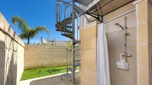 A spiral staircase leading to a shower area with a metal handrail and a white showerhead. - 3844 Villetta Della Poesia by Barbarhouse (Melendugno)