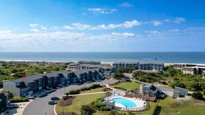 A coastal hotel with multiple-story buildings, a swimming pool, and a view of the ocean. - Atlantic Beach Getaway Spacious 3-Level Condo: Walk to the Beach & Pool (Atlantic Beach)