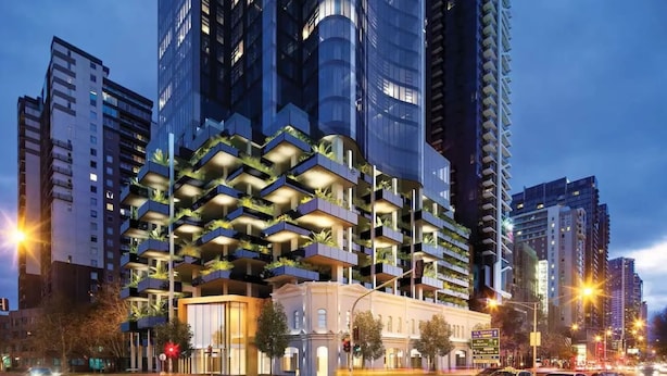 A modern high-rise building with multiple balconies and a mix of residential and commercial spaces. - Stunning 1-bed Unit in 56th Floor in Southbank! (Southbank)