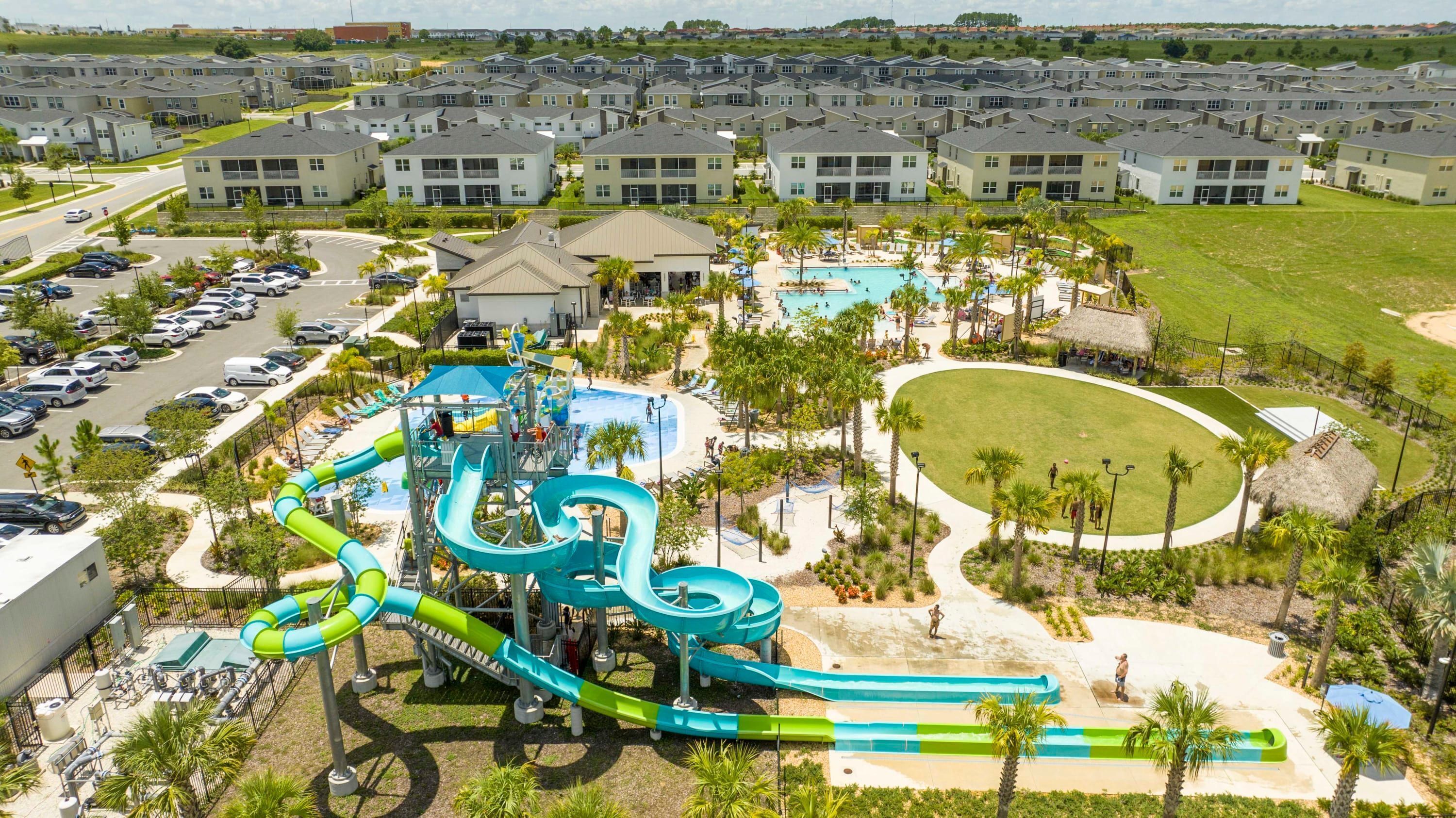 A water park with slides and pools, surrounded by apartment buildings.