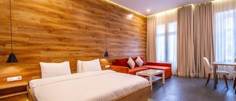 Deluxe Double or Twin Room | Living area | 55-inch Smart TV with cable channels