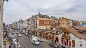 A street view with buildings, cars, and pedestrians.