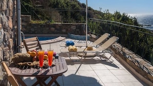 An outdoor patio with a table, chairs, and a pool. - Seaview villa w/private pool near Elafonissi beach (Chania)