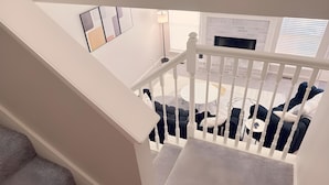 A staircase with a white railing leading to a balcony with outdoor seating. - 4 bedrooms+Outdoor gazebo+Garage+office (Tulsa)