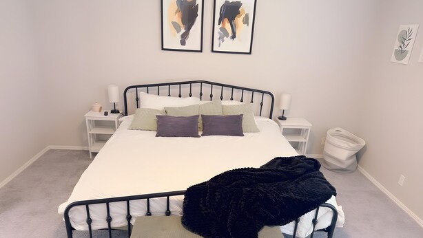 A neatly arranged bedroom with a bed, bedside tables, a bench, and two framed artworks on the wall. - 4 bedrooms+Outdoor gazebo+Garage+office (Tulsa)