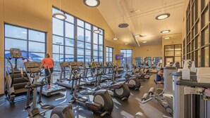 A gym with multiple treadmills, stationary bikes, and weight machines. - House 3bd-3bth-fire pit-screen porch-outdoor pool - close to everything (Galena)
