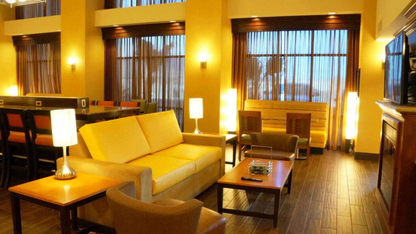 Unwind on plush seating with warm lighting and calm vibes.
