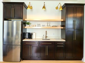 Full-sized fridge, microwave, stovetop, coffee/tea maker