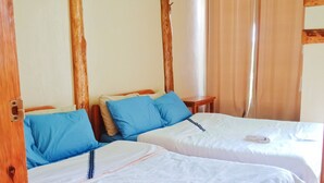 A room with two wooden beds, each with a white mattress and blue pillows. - FUSIONED AESTHETIC-RUSTIC RMS AT BOONE'S (Sagada)