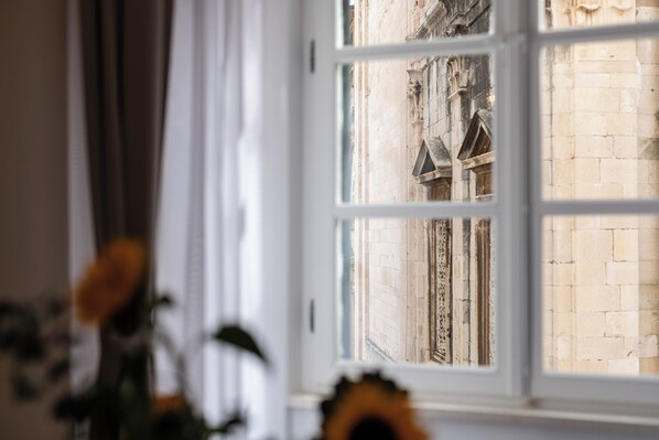 A window with a view of a brick building.