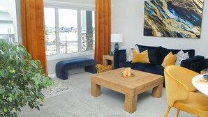 A modern living room with a sofa, coffee table, and a lamp. - Bright and sunny 1-bdr guest suite in South Calgary (De Winton)