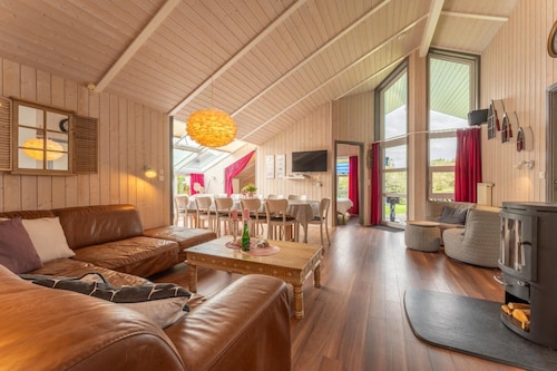 12 person family holiday home with sauna, whirlpool, two showers and toilets, wood-burning stove and canoe in 1st row to the lake with wonderful lake view in Otterndorf