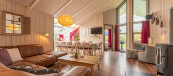 12 person family holiday home with sauna, whirlpool, two showers and toilets, wood-burning stove and canoe in 1st row to the lake with wonderful lake view in Otterndorf