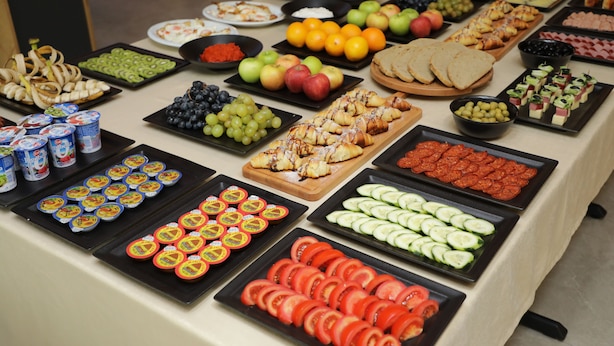 A buffet with various food items including fruits, vegetables, and pastries. - Andoena Resort (Lipjan)