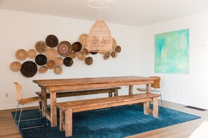Enjoy meals in this cozy dining area with a rustic table and comfortable benches.