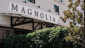 A building with the sign "MAGNOLIA" prominently displayed. - Central! Minutes to Magnolia, Baylor University, Cameron Park  Zoo and more.  (Waco)