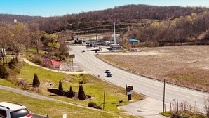 A highway interchange with multiple lanes, a gas station, and a small commercial building.