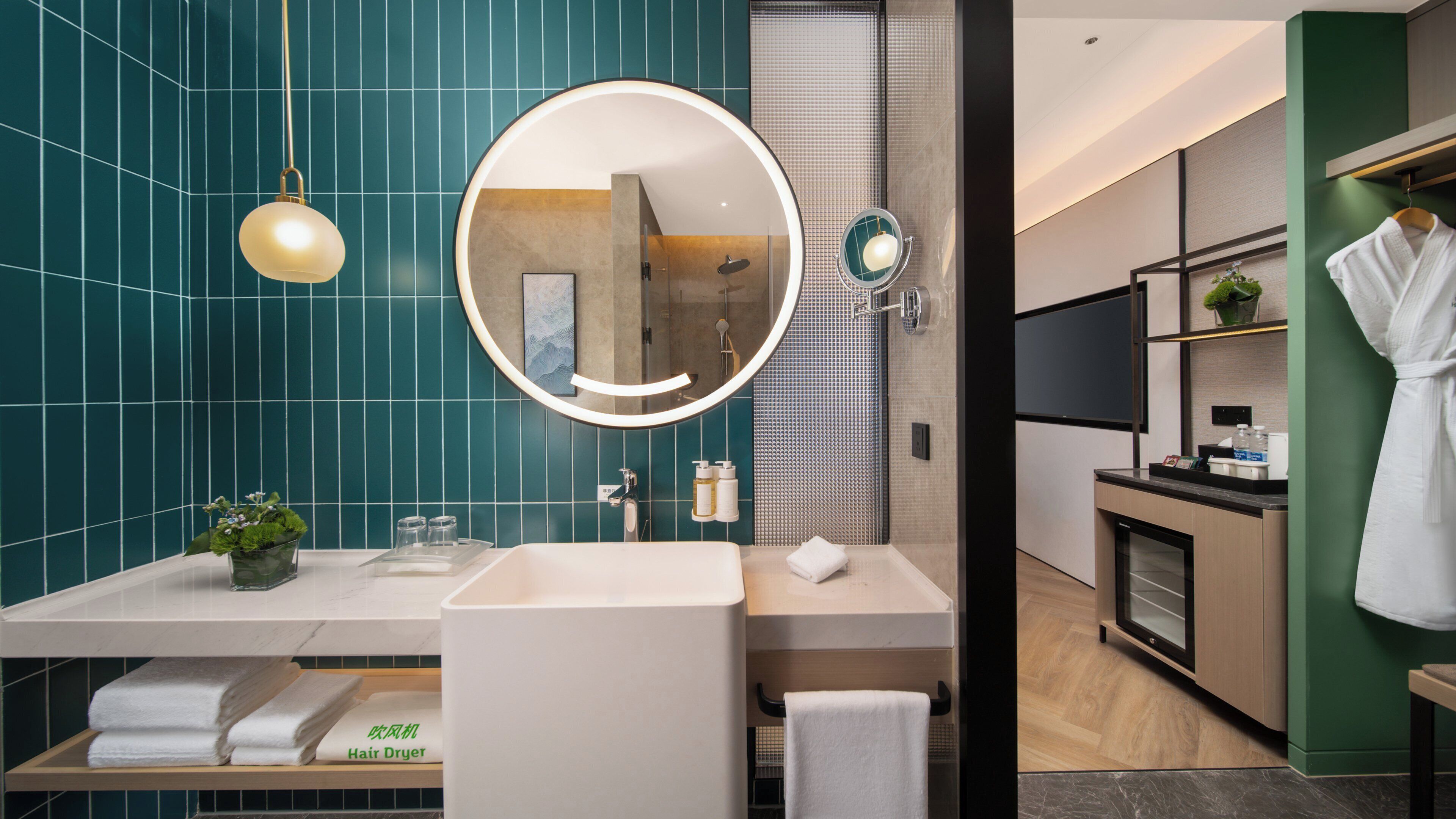 A modern bathroom with a dual sink vanity, a large mirror, and a hair dryer.