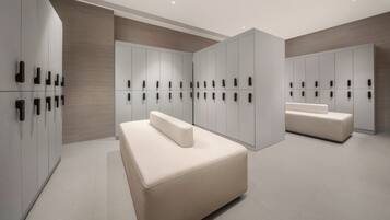 Relax in a spacious room with a large L-shaped bed and adjacent wardrobe.