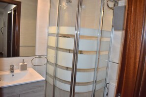 Shower, hair dryer, towels, toilet paper